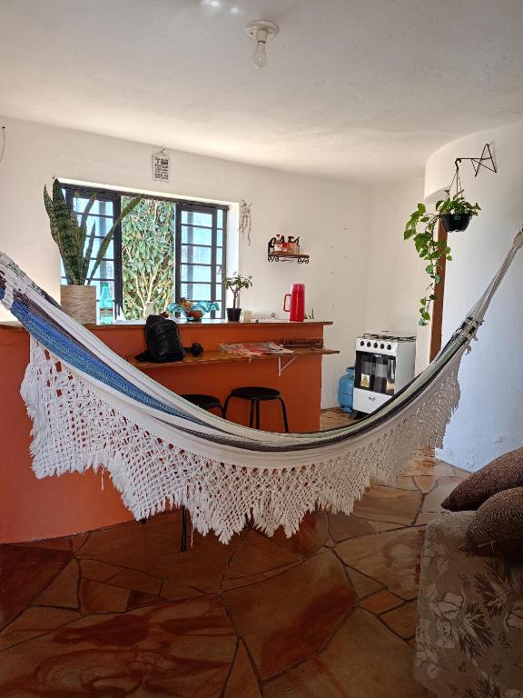 un'amaca in un soggiorno con una scrivania di Casa Nova Terra a São Thomé das Letras