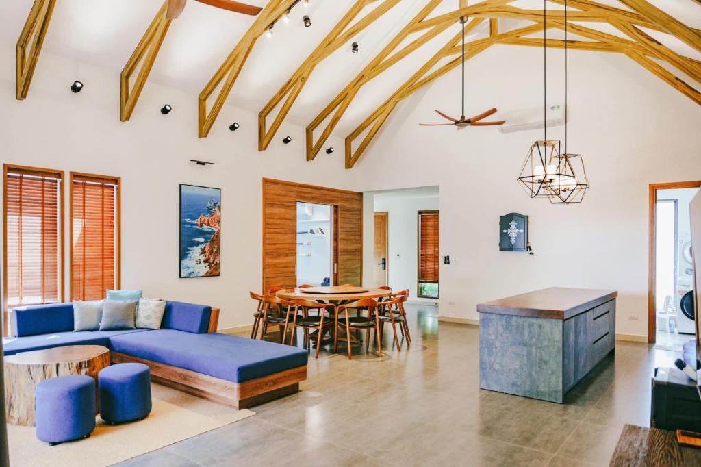 a living room with a blue couch and a table at Villa Luxury 3 Phòng ngủ Private Pool - Coastar Hồ Tràm in Long Hai