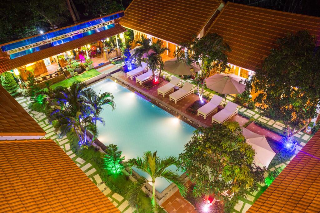 an overhead view of a swimming pool at night at Little Garden Bungalow in Phú Quốc
