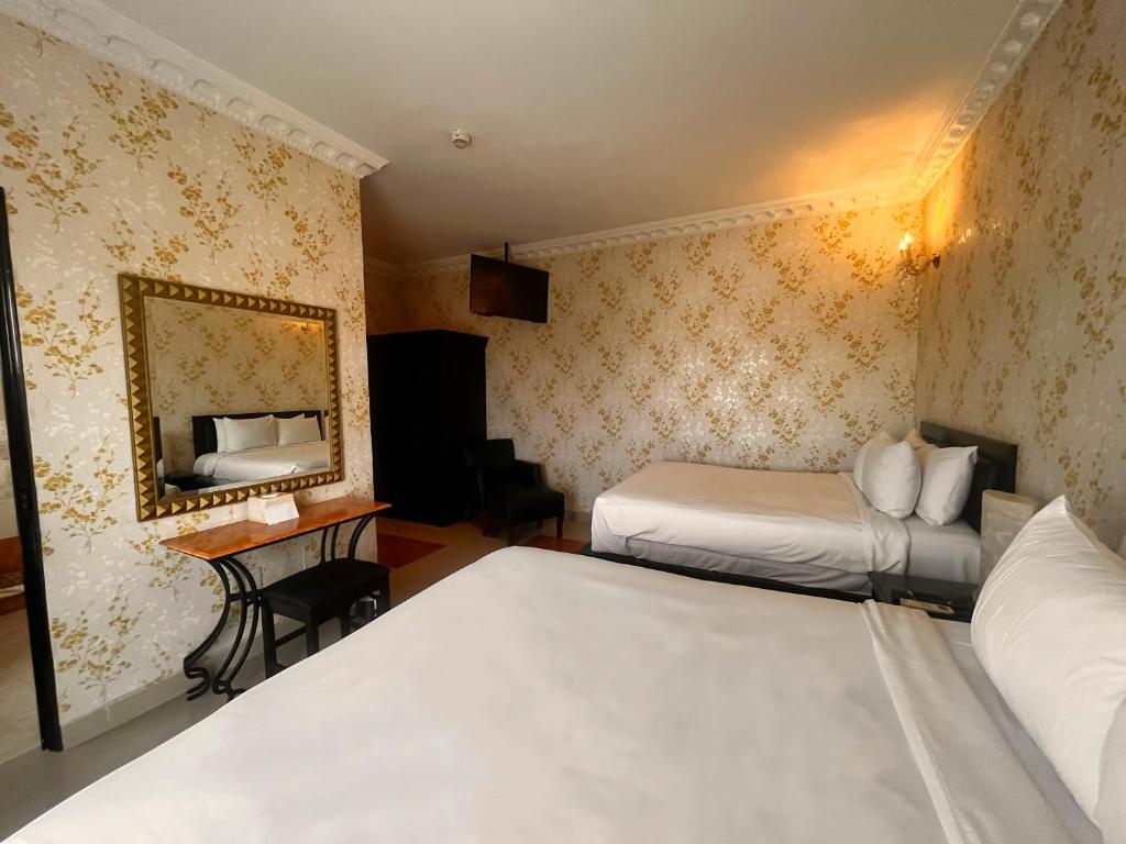 Postel nebo postele na pokoji v ubytování Hotel Palacio Maya