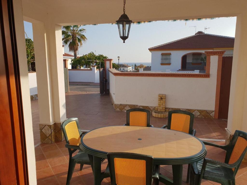 a table and chairs on a patio with a view of the ocean at Matalascañas MAR in Matalascañas