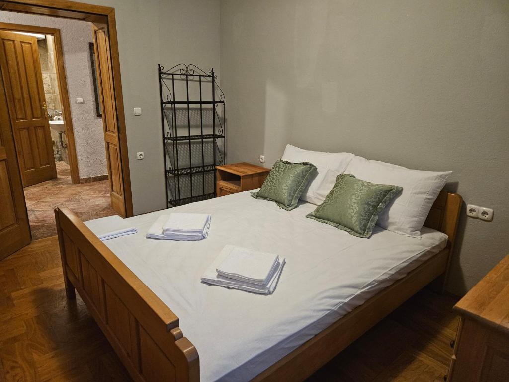 a bedroom with a large bed with towels on it at Saint George Apartment in Split