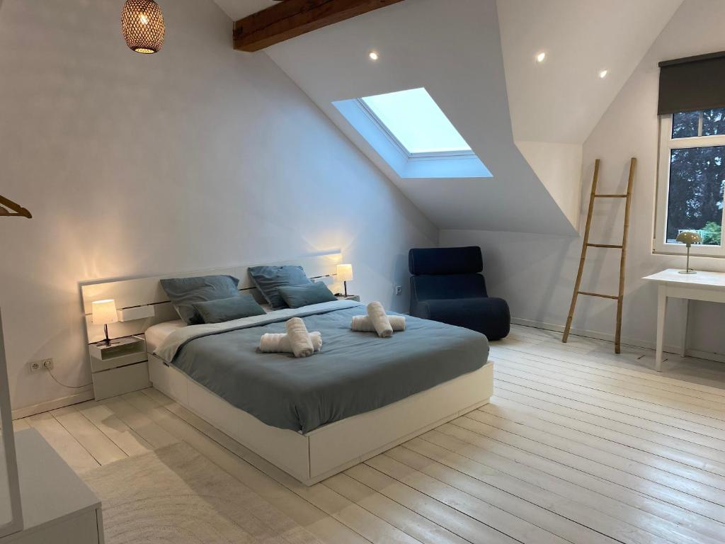a bedroom with a bed with two stuffed animals on it at Old Town Suites in Malmedy