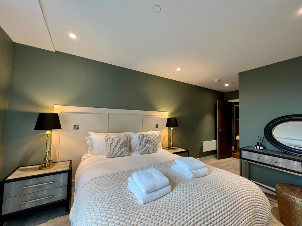 a bedroom with a large white bed with two pillows at The Card Room at Ryedale House in York