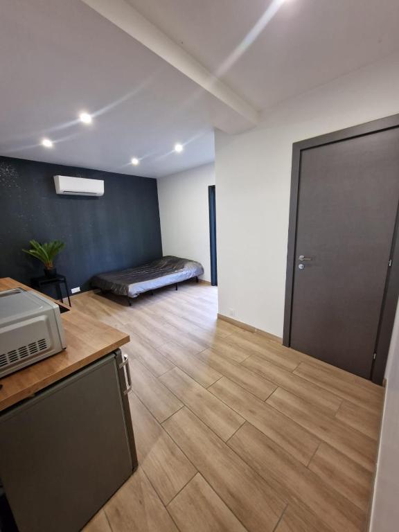 une chambre avec un lit dans le coin d'une pièce dans l'établissement Studio en bord de mer avec jardin proche de Montpellier, à Villeneuve-lès-Maguelone