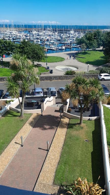 a park with palm trees and a marina with boats at Astala Lodge in Bangor