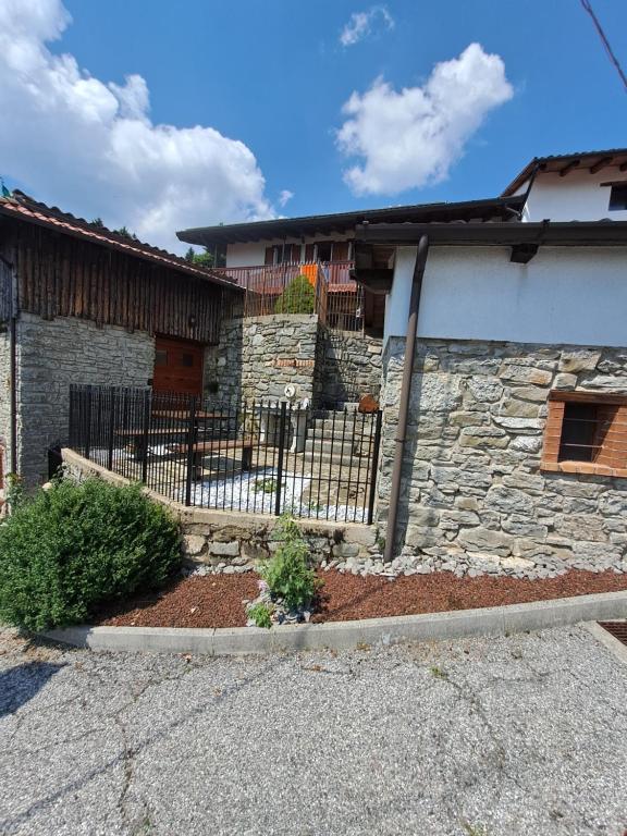 a fence in front of a house at Casa Scarbini in Savogna