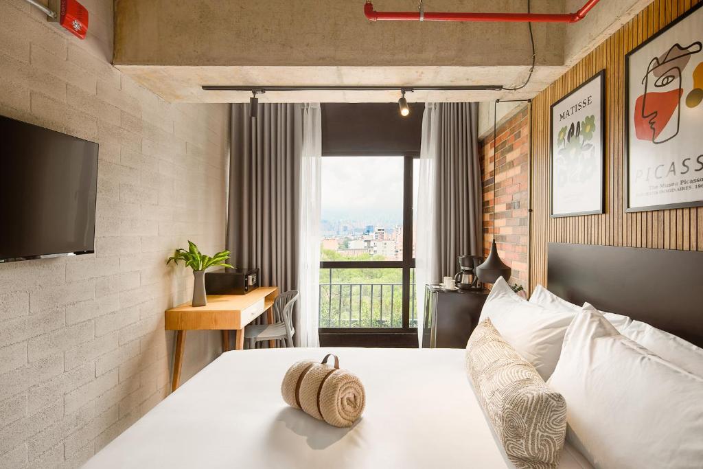Postel nebo postele na pokoji v ubytování Urbit Social Lofts