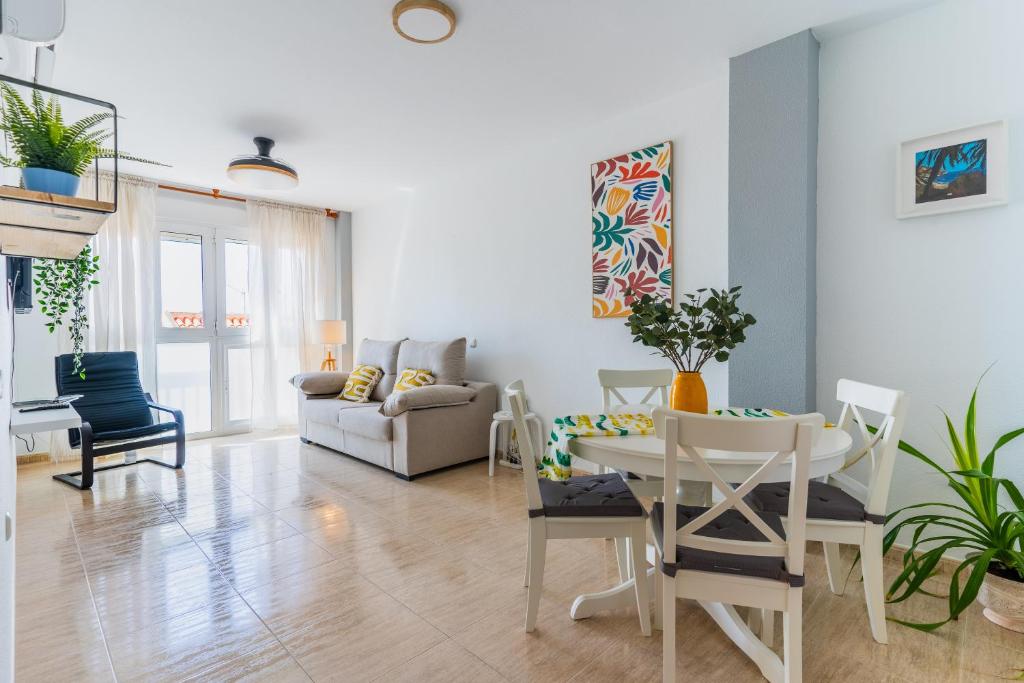 a living room with a table and chairs at Apartamento Paquita R&R in Aguadulce