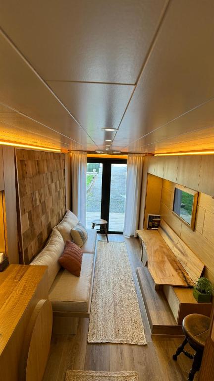 a living room with a couch and a table at City Hideaway, Off Grid Luxe in Lancaster