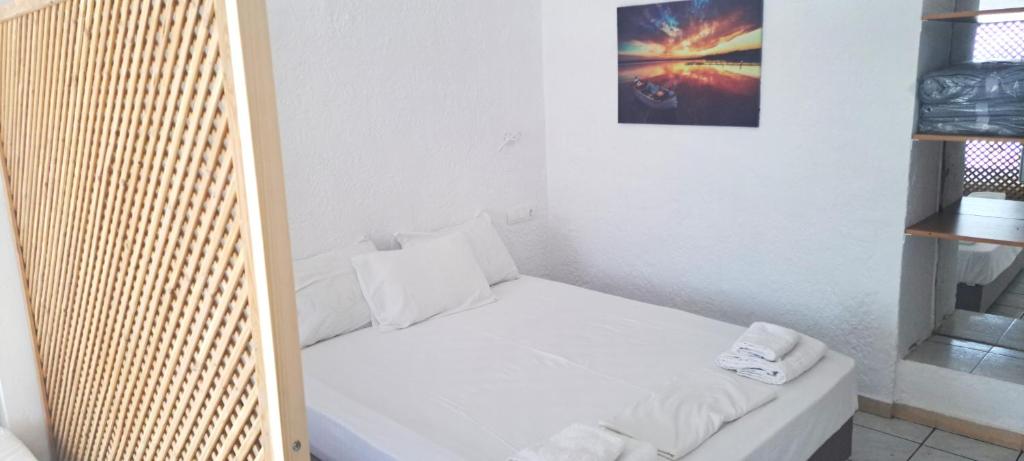 Postel nebo postele na pokoji v ubytování Jimmy's Apartments