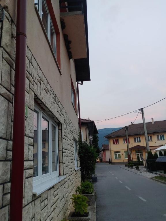 a building with a window on the side of a street at Apartman Kulenović in Kulen Vakuf