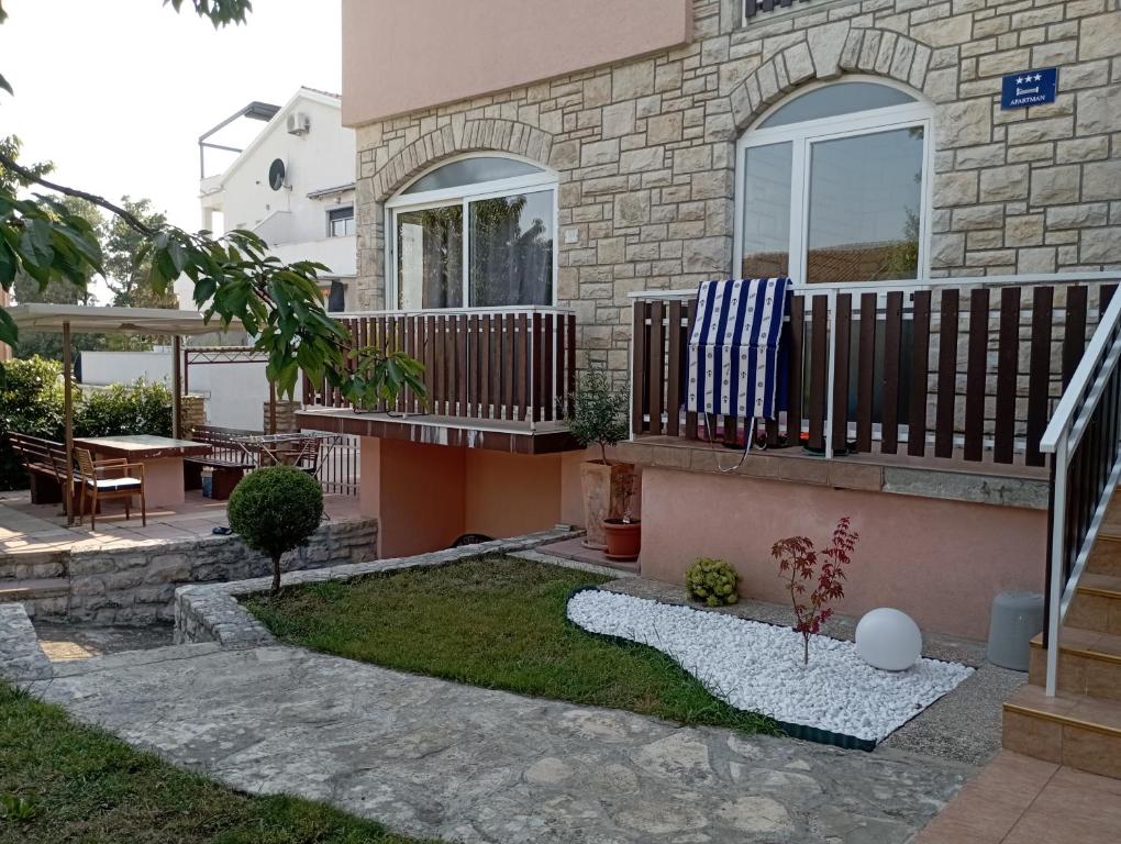 a house with a balcony and a patio at Apartman Sole in Karigador