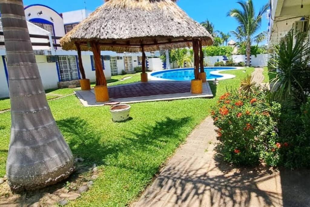 a backyard with a gazebo and a swimming pool at Lugar auténtico para vacacionar in La Sabana