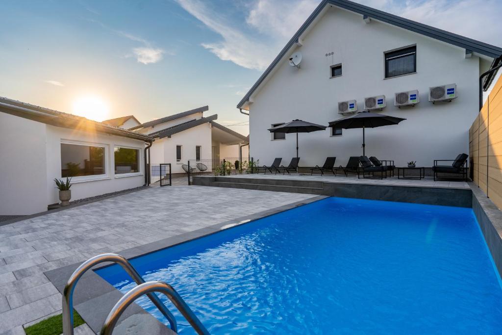 a swimming pool in the backyard of a house at Apartments & Room Forest in Slunj