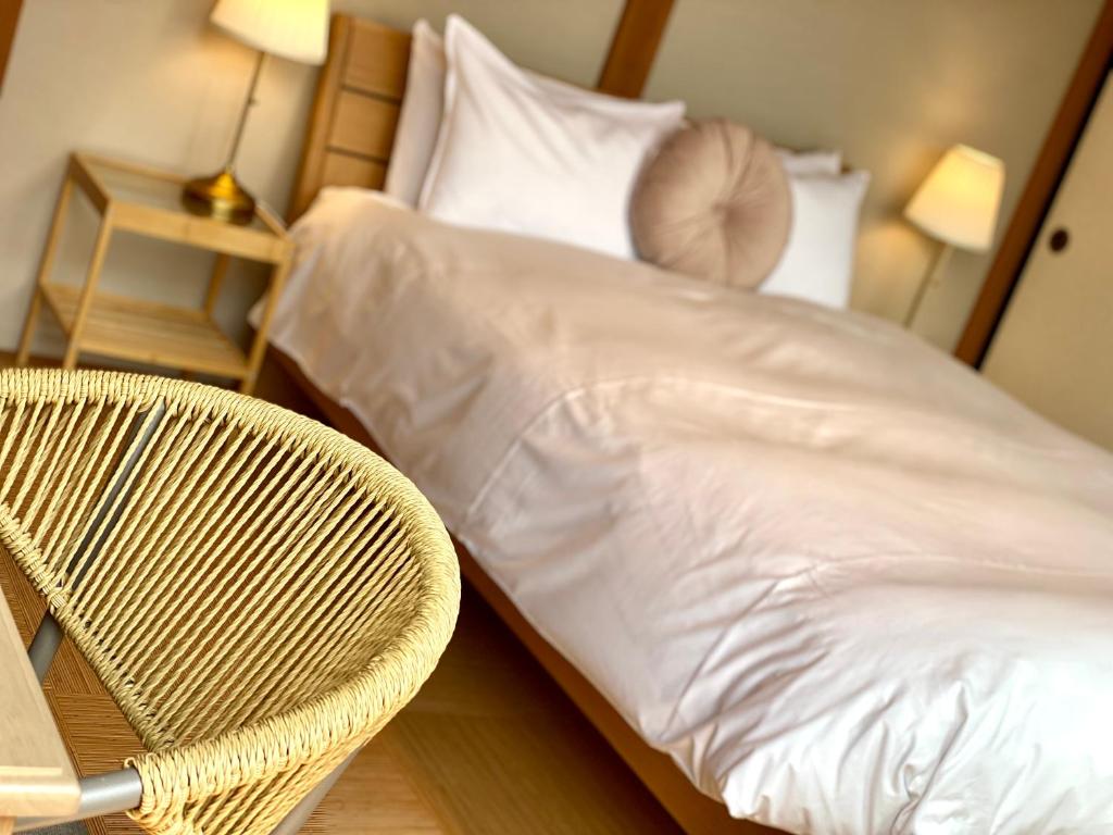 Postel nebo postele na pokoji v ubytování Togari Inn Suites