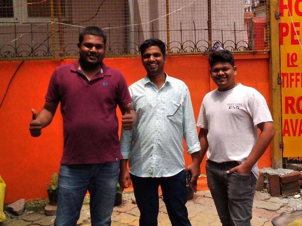 a group of three men standing next to each other at Hotel PENTOZ - Rose Garden, Ooty in Ooty