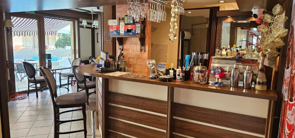 a bar in a restaurant with a table and chairs at Apart-Hotel Onegin & Thermal Zone in Sozopol