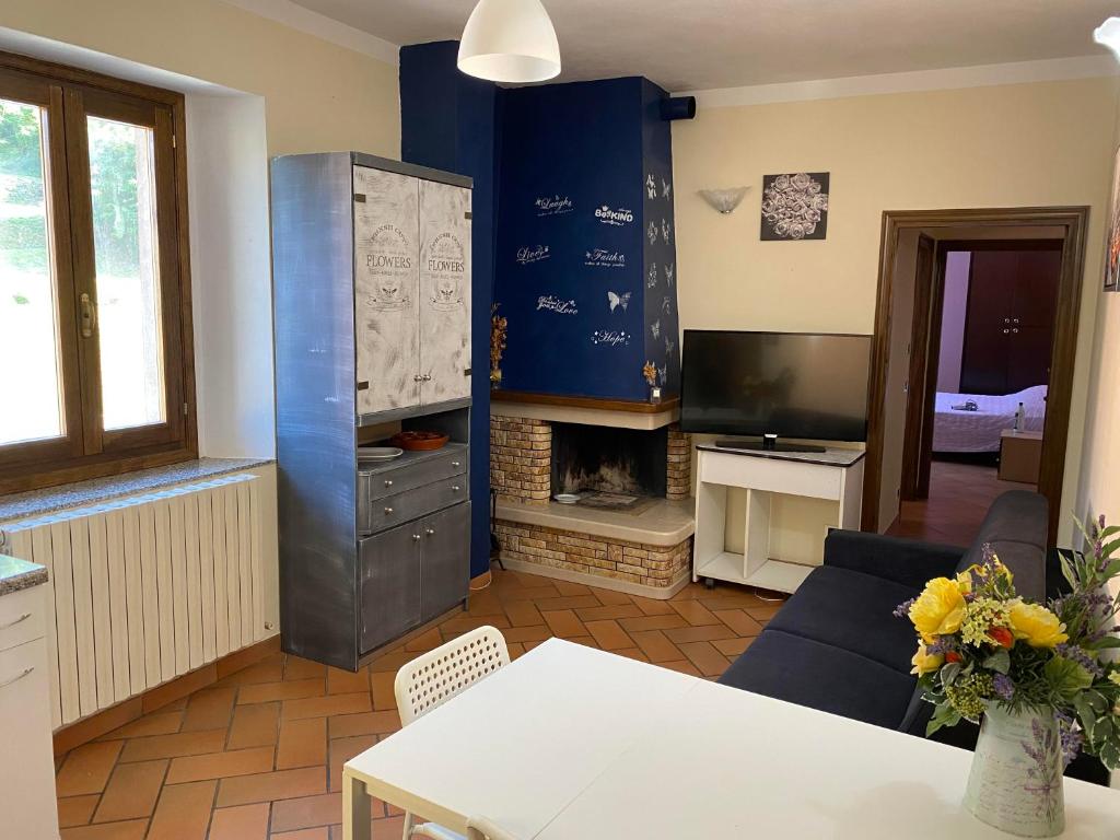 a living room with a table and a fireplace at Appartamento Piazza Montese 2 in Montese