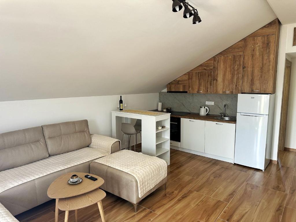 a living room with a couch and a kitchen at Nirvana S in Tivat