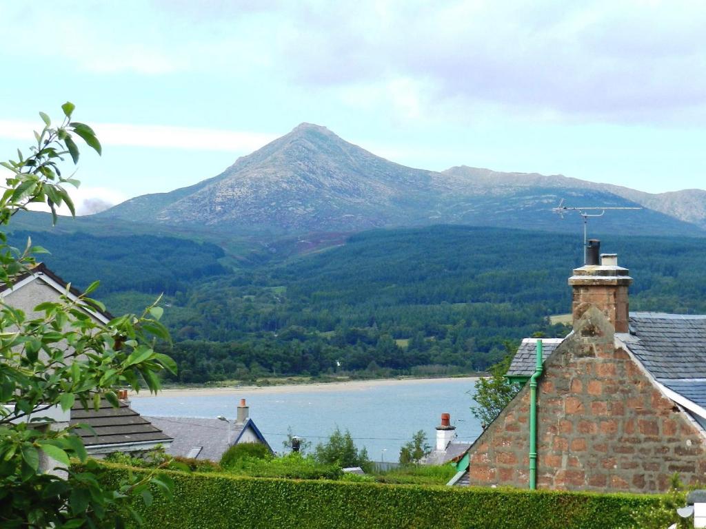 a house with a view of a lake and mountains at Hartholm in Brodick