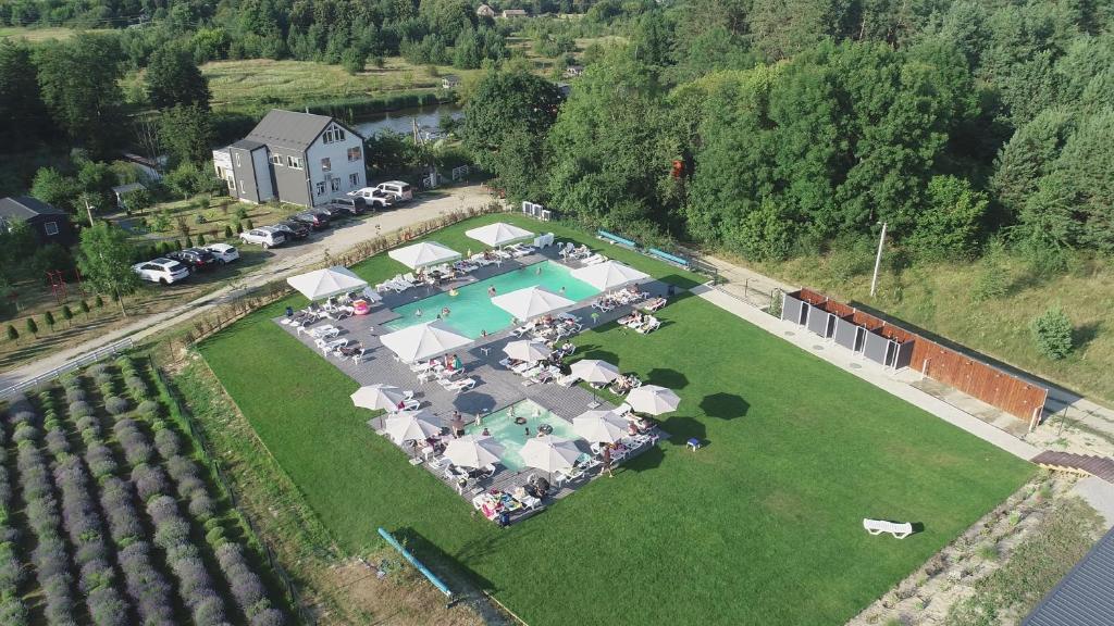 an aerial view of a large lawn with a swimming pool at Відпочинковий Еко комплекс "Затишна садиба" in Luchin