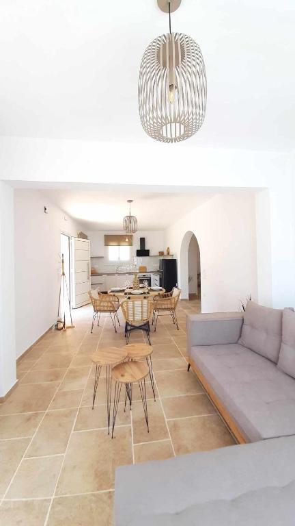 a living room with a couch and a table at Rozas house in Benitses