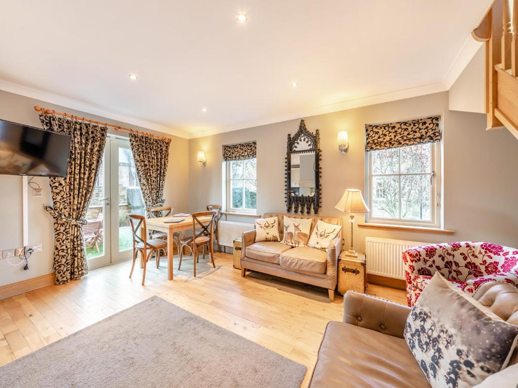 a living room with a couch and a table at Cloister Cottage - Uk3463 in Ellingham