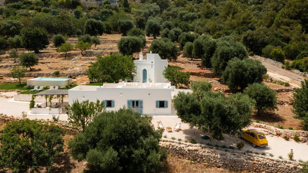 an aerial view of a white house with trees at Torretta Le Feritoie - piscina e terrazza vista mare in Fasano