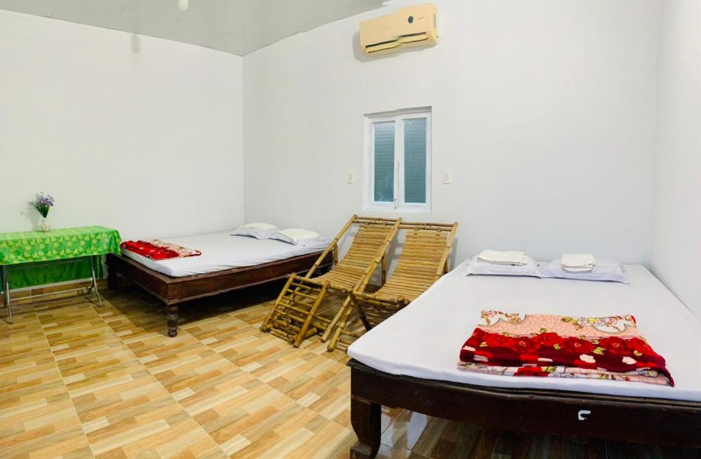 Postel nebo postele na pokoji v ubytování Ben Tre Inn