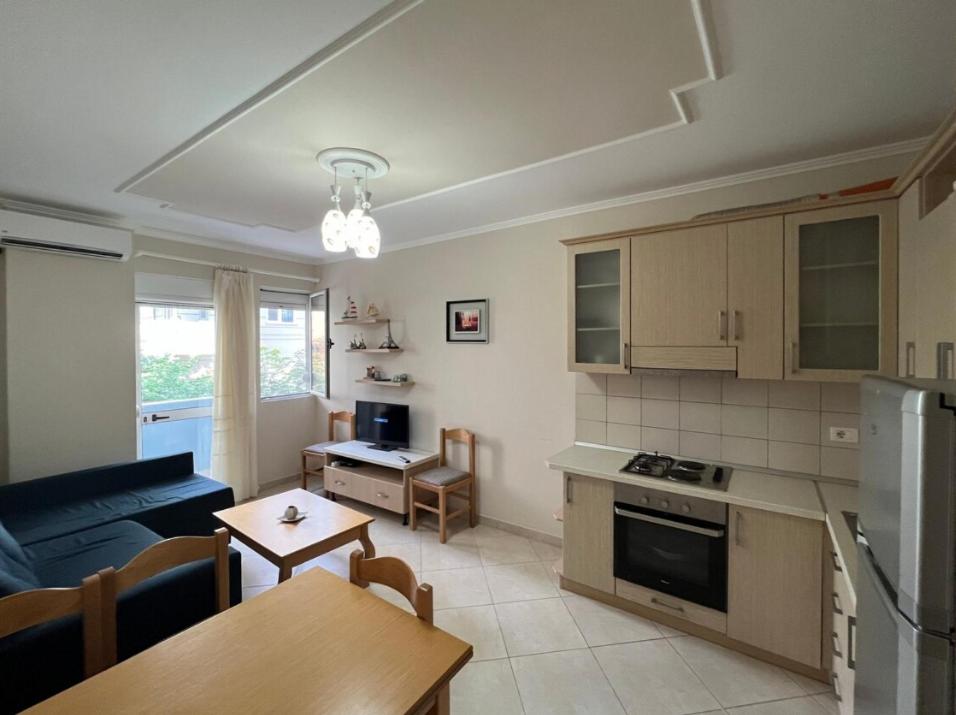 a kitchen and living room with a couch and a table at Daniels apartment in Shëngjin