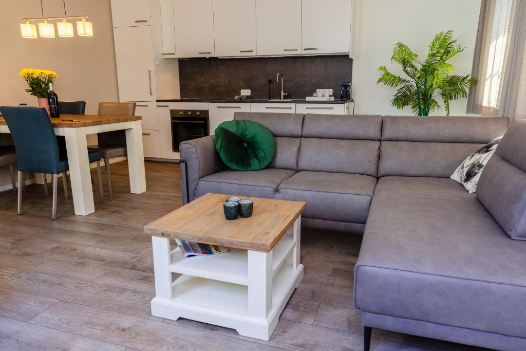 a living room with a couch and a table at De Nagtegaal in Hollum
