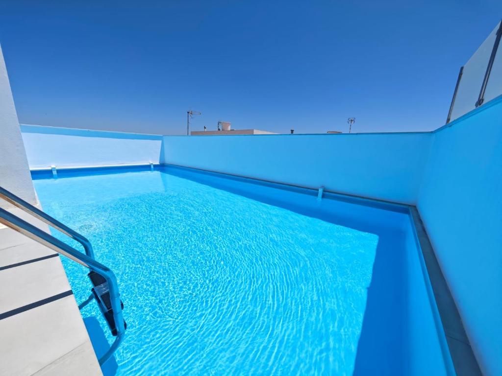 a swimming pool in a house with blue lights at Apartamento a estrenar en Planta Primera C con piscina in Barbate