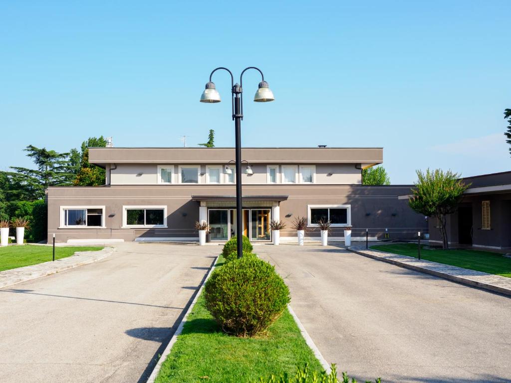 a building with a street light in front of it at Hotel Altamira in Orsogna