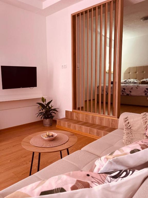 a living room with a couch and a table at Studio apartman Ana in Livno