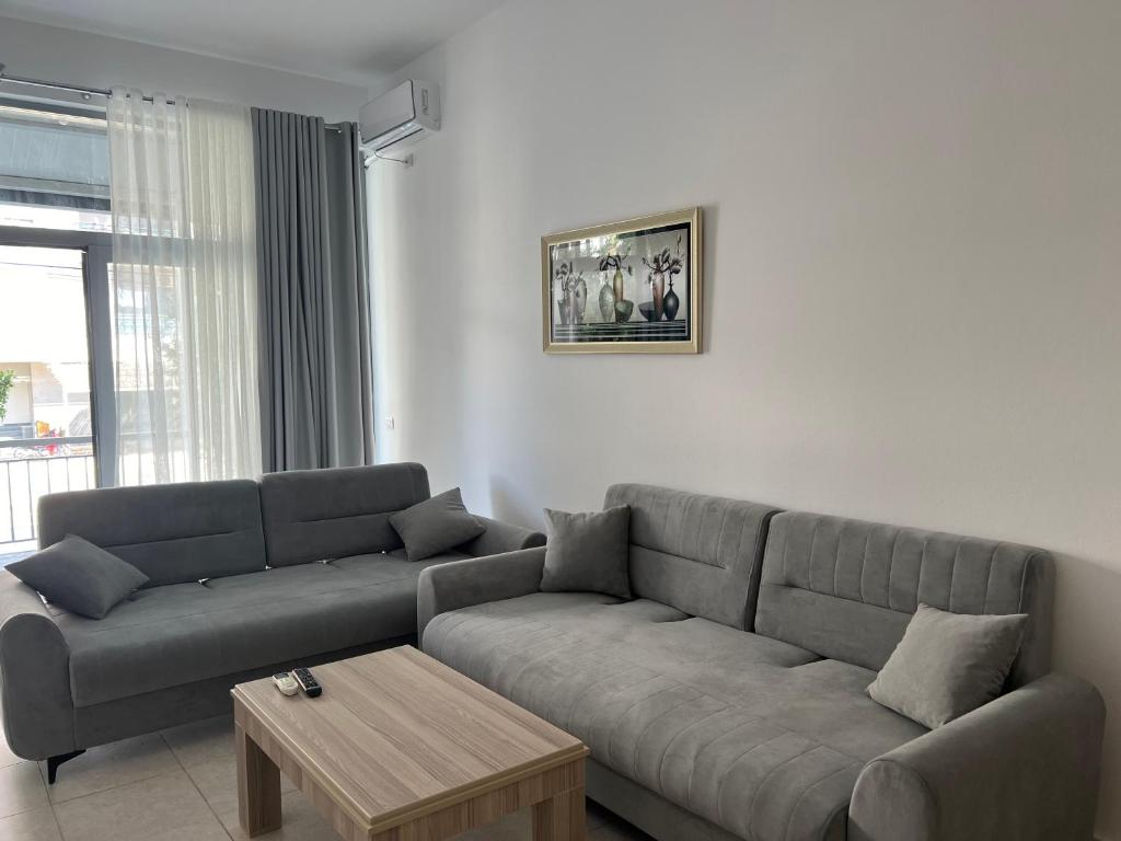 a living room with a couch and a coffee table at Ameti - Ground Floor Comfort Suites - Spacious & Modern in Orikum