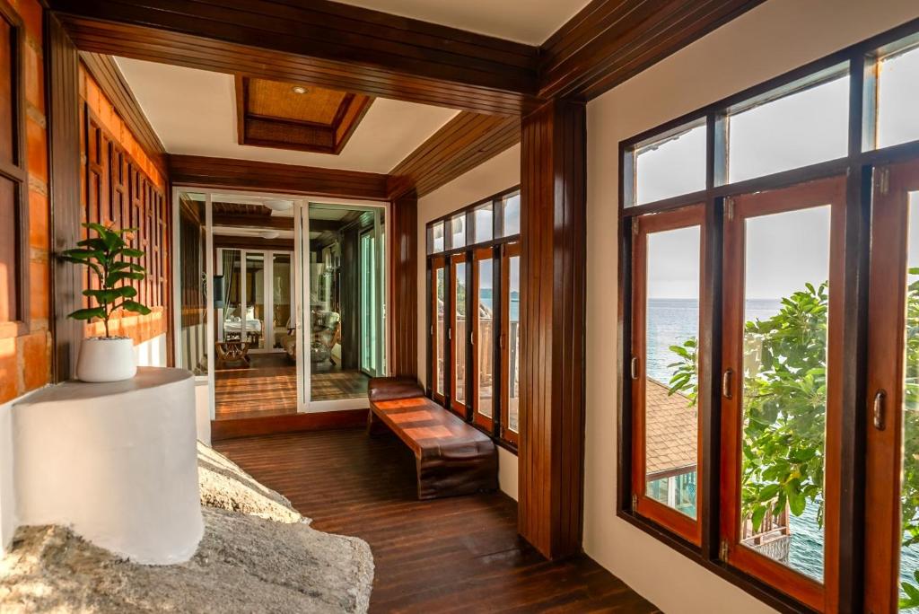 a living room with a view of the ocean at Dusit Buncha Koh Tao by Riya Group in Ko Tao