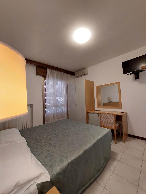 Postel nebo postele na pokoji v ubytování Hotel Nettuno