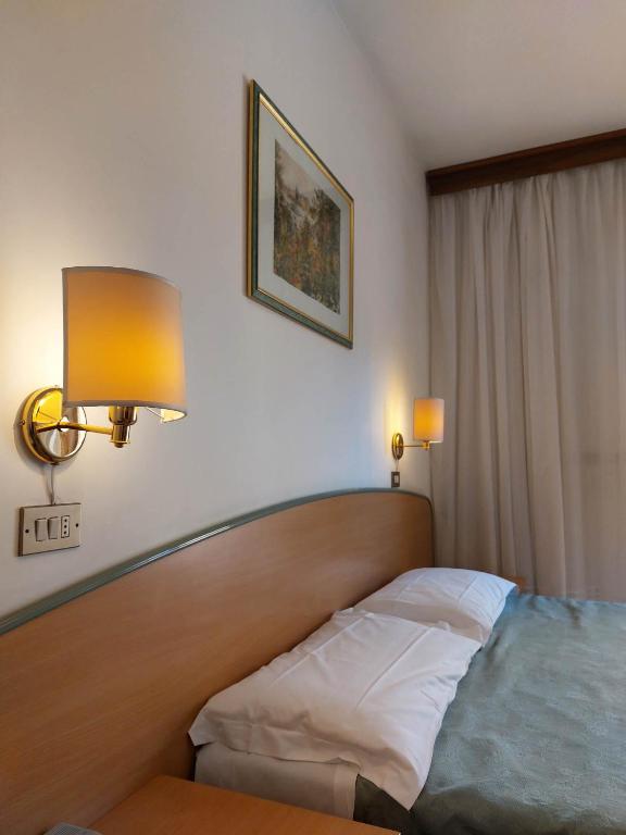 Postel nebo postele na pokoji v ubytování Hotel Nettuno