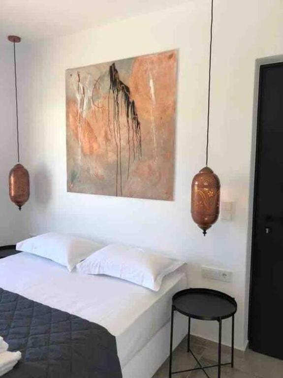 A bed or beds in a room at Mikri Sorriso - Luxurious Villa On The Beach