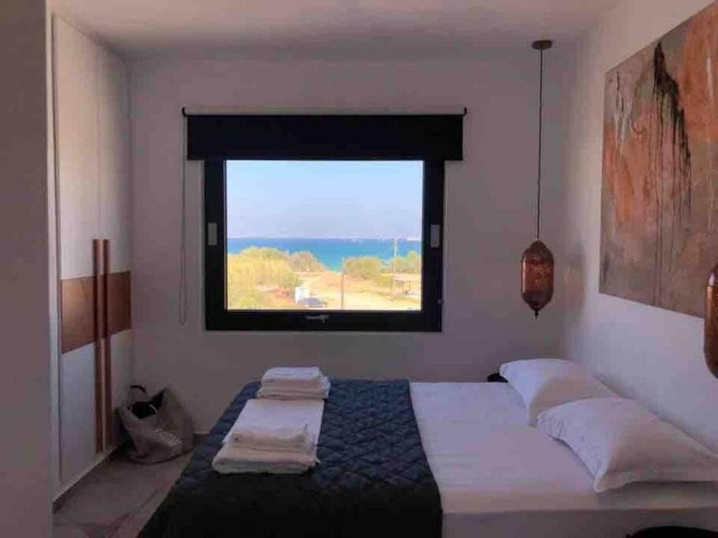 A bed or beds in a room at Mikri Sorriso - Luxurious Villa On The Beach