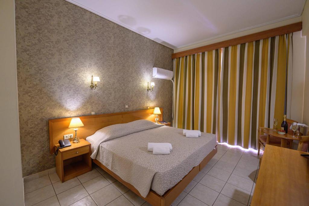 Postel nebo postele na pokoji v ubytování Neda Hotel