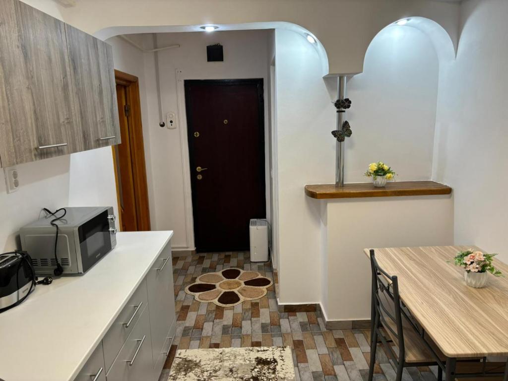 a kitchen and dining room with a table and a television at David și Daria in Vaslui