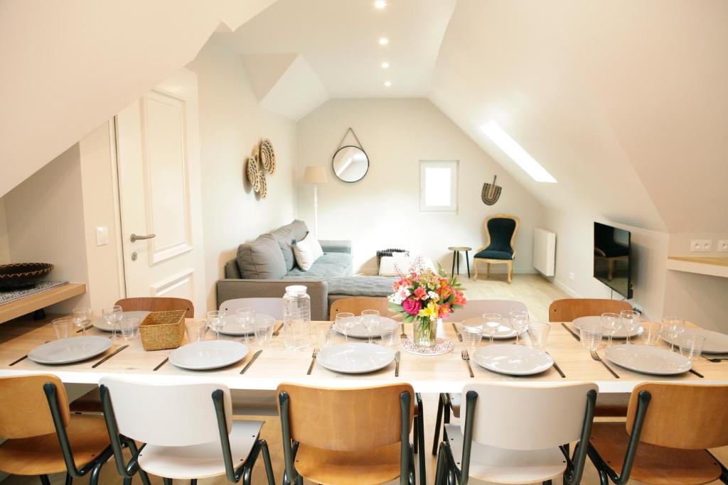 a large dining room with a table and chairs at Le grand Loré in Sainte-Suzanne