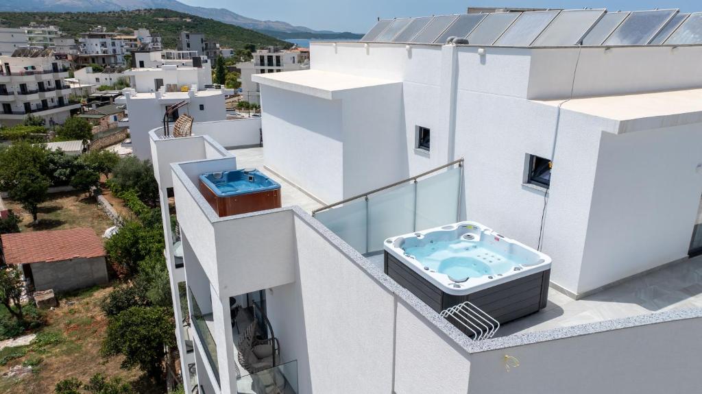a balcony with a hot tub on a building at Duka's Hotel in Ksamil