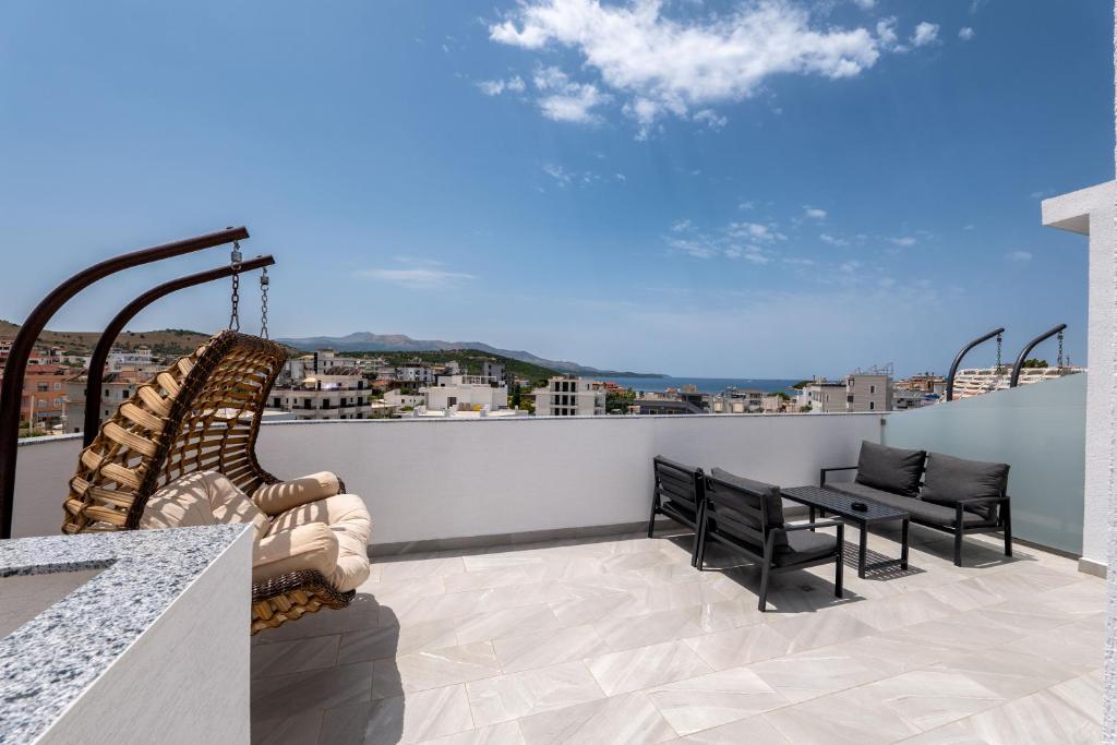 a balcony with a table and chairs and a view at Duka's Hotel in Ksamil