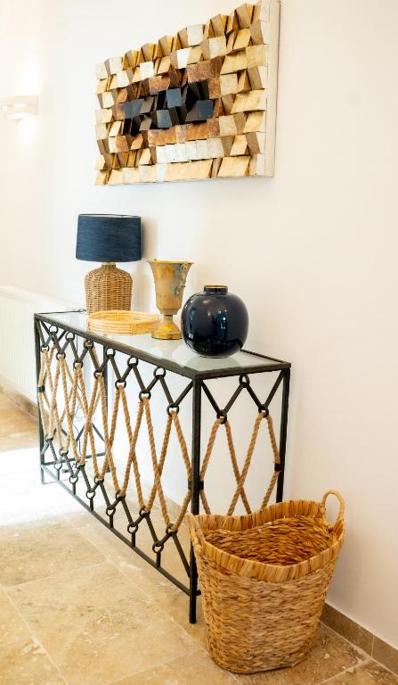a black console table with a basket on it at Vila Valeria in Techirghiol