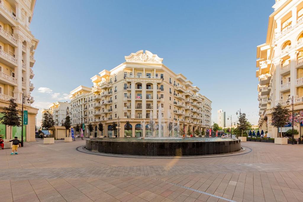 a large building with a fountain in front of it at 7, 8, Tashkent City Park, Boulevard, 51m2 in Tashkent