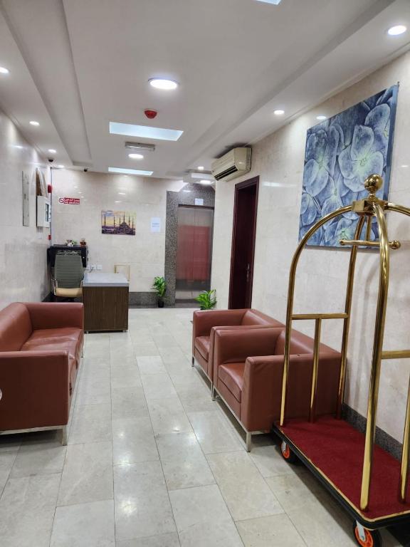 a waiting room with brown leather couches in a hospital at iQama 2 in Salalah
