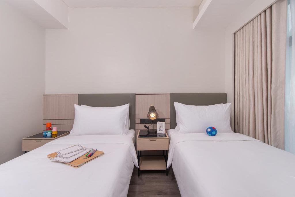 Postel nebo postele na pokoji v ubytování Citadines Bacolod City